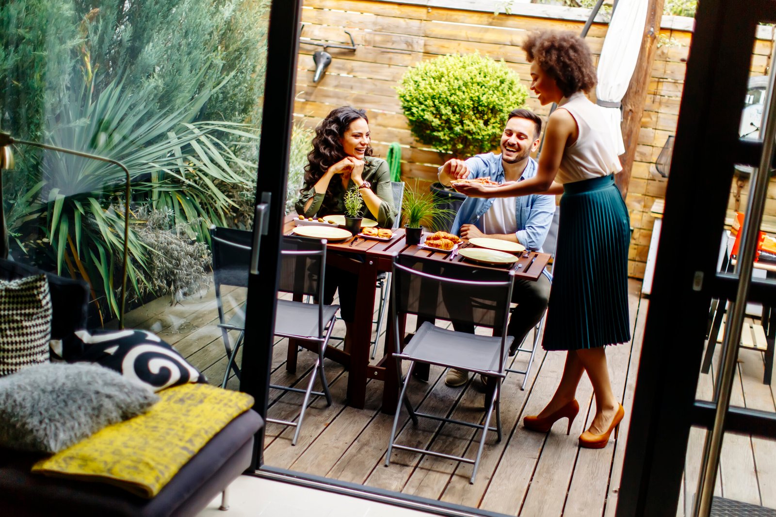 Cheerful young people have lunch in the courtyard and have a fun